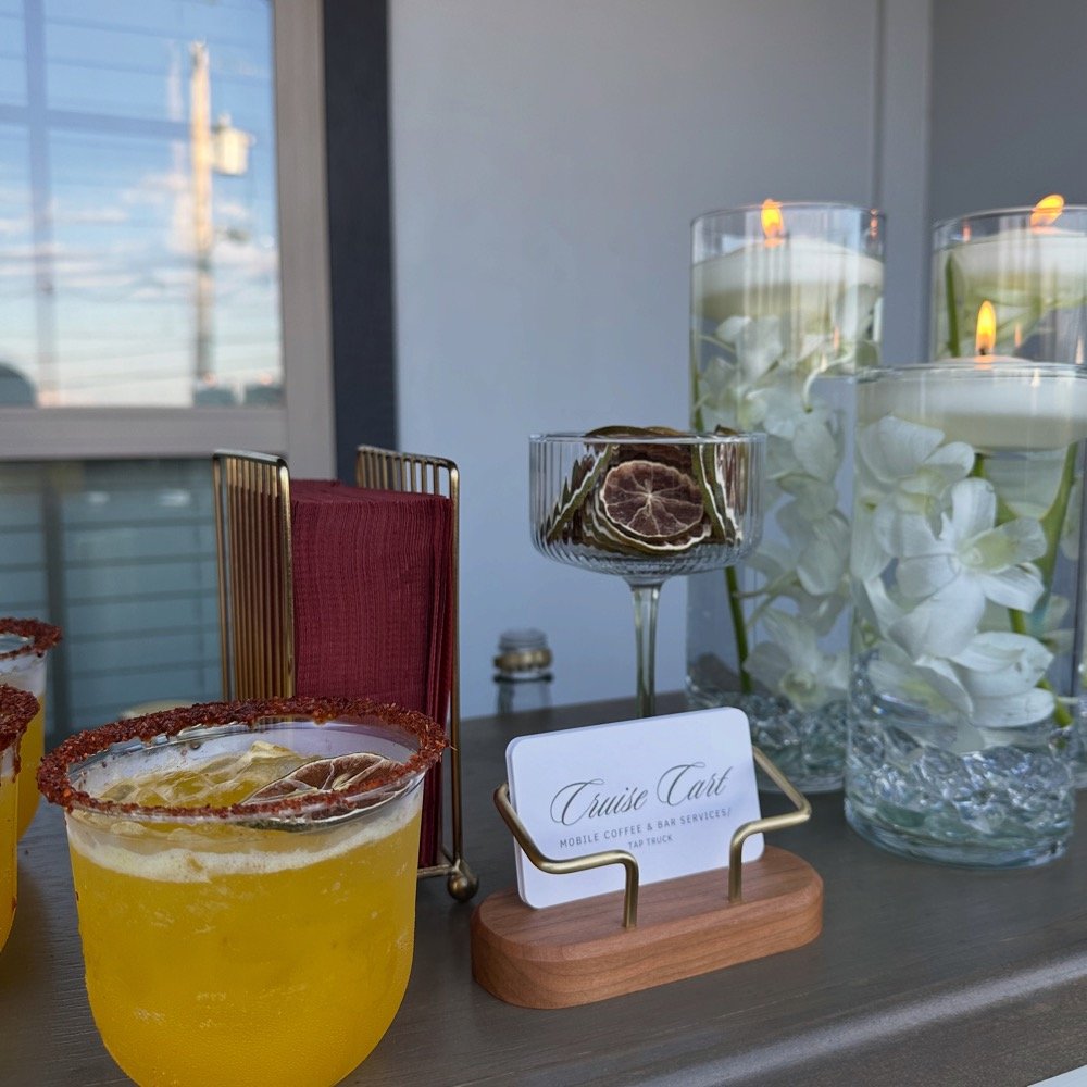 Bar setup with cocktails and floral decor